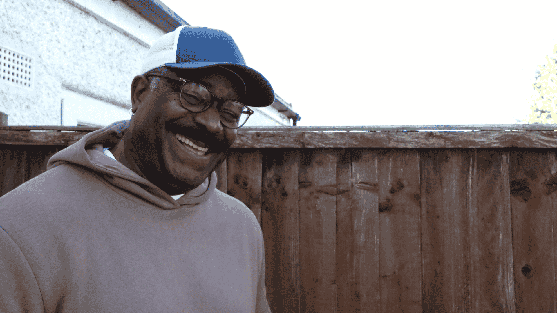 A man smiling and looking into the camera